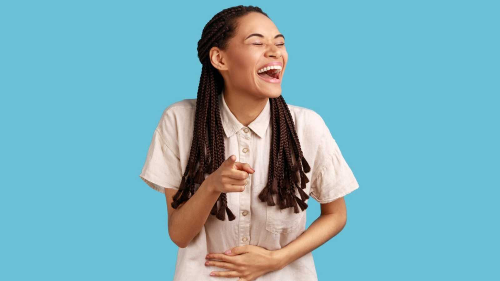 Woman pointing and laughing