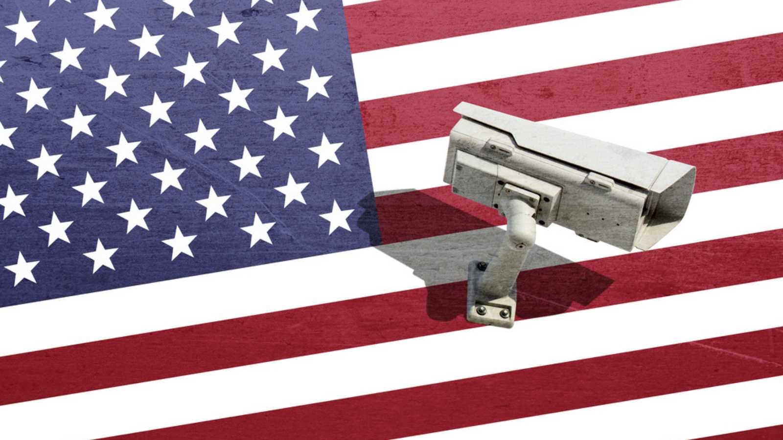 Security CCTV camera surveillance system on the broken dirty background USA flag