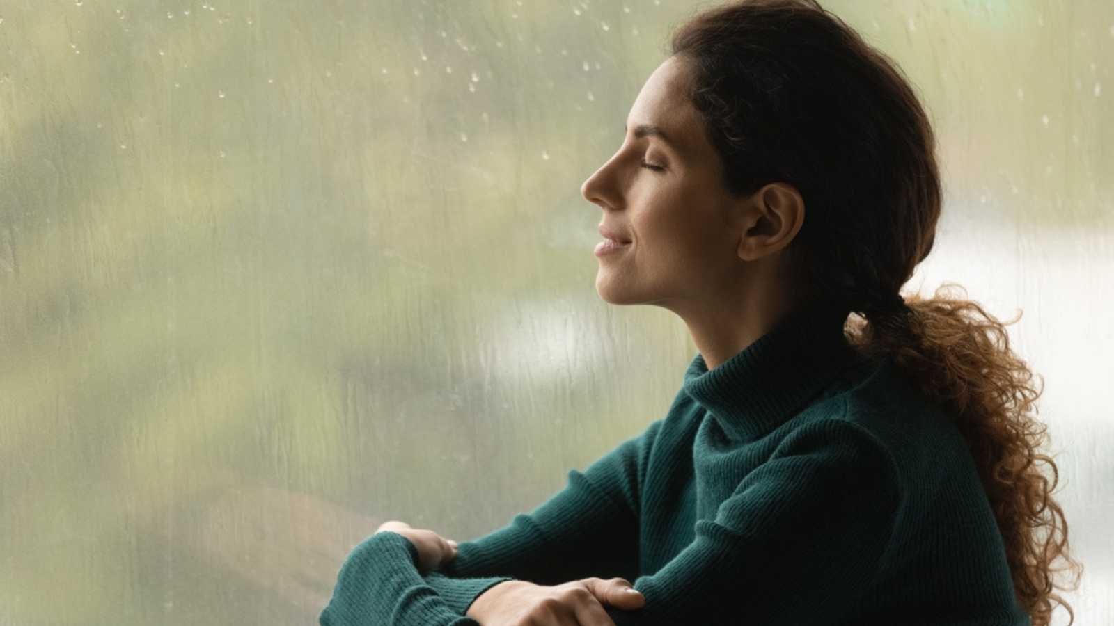 Woman calmly enjoying rain