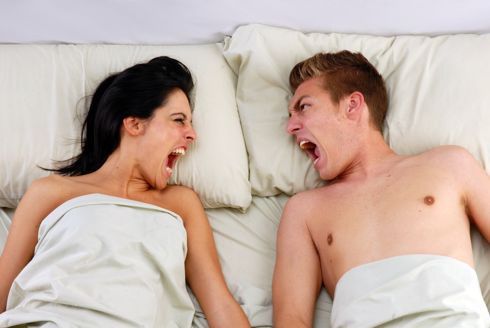 Couple in bed fighting