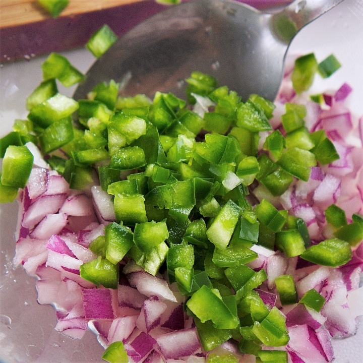 making gaucomole with onions and peppers
