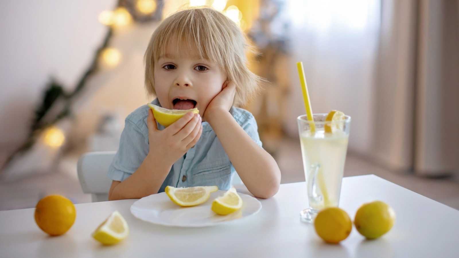 Kid tasting lemon
