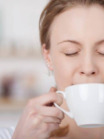 woman blissfully drinking coffee